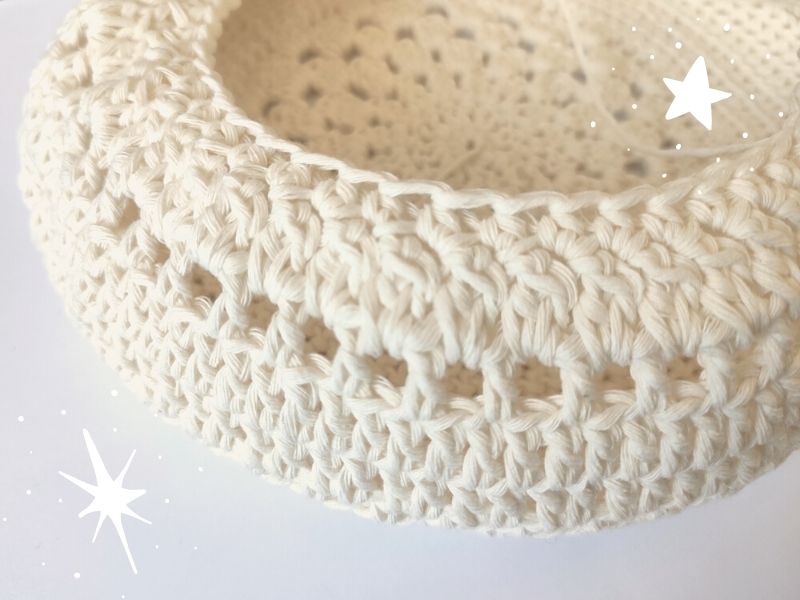 A white crocheted basket with stars on it.