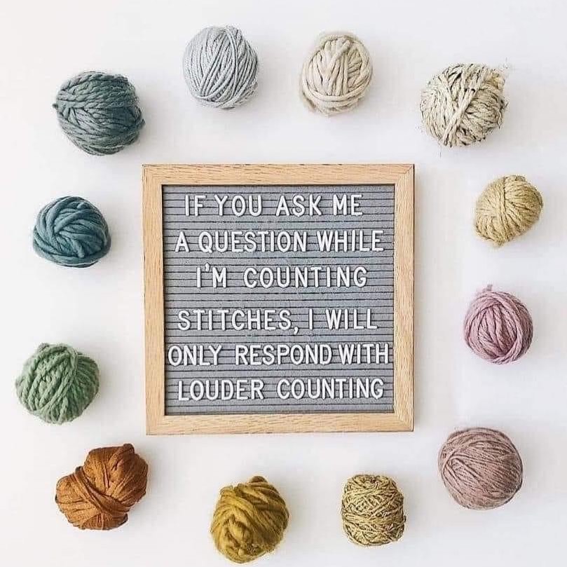 board with funny text and yarn