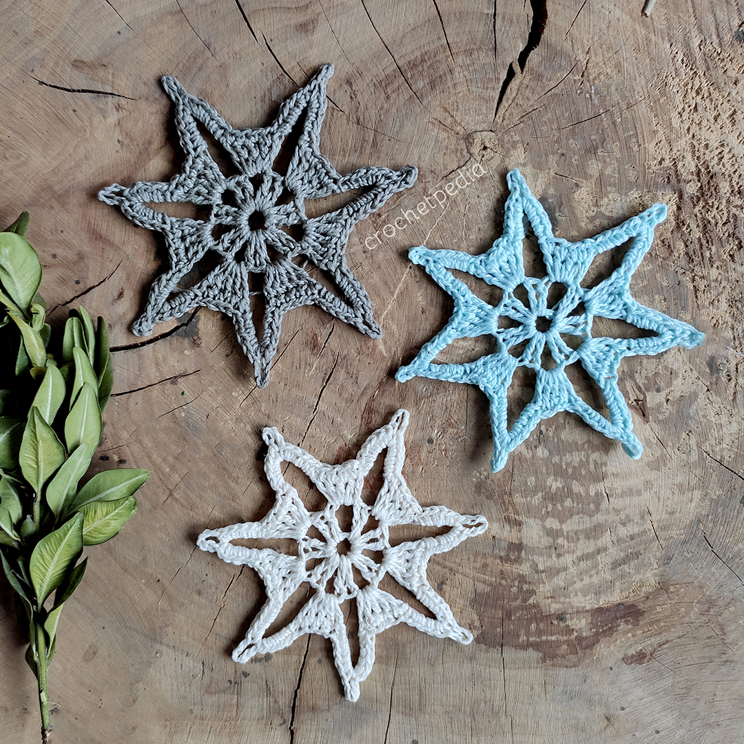three small snowflakes in different colors