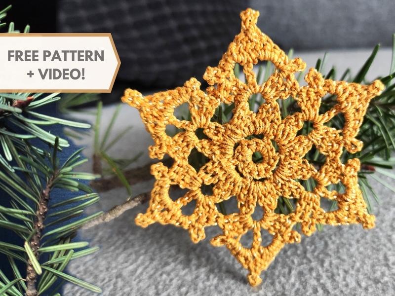 A crocheted snowflake ornament with the words free pattern video.